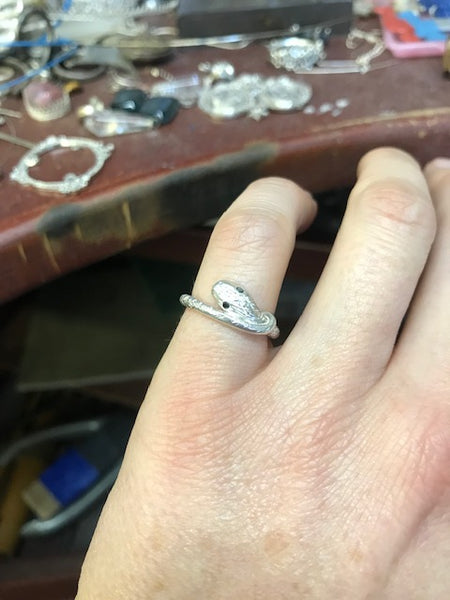 Silver snake ring with black eyes